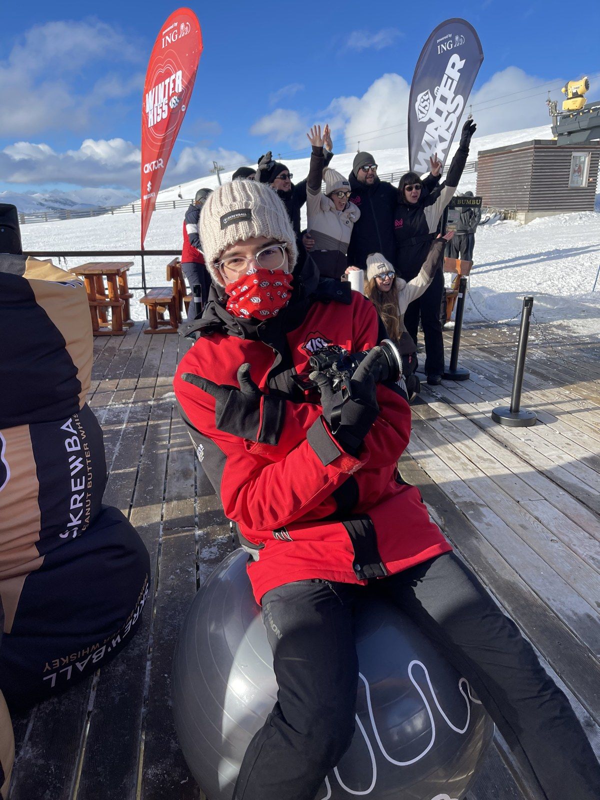 Matei on the slopes at an après-ski party, holding his camera